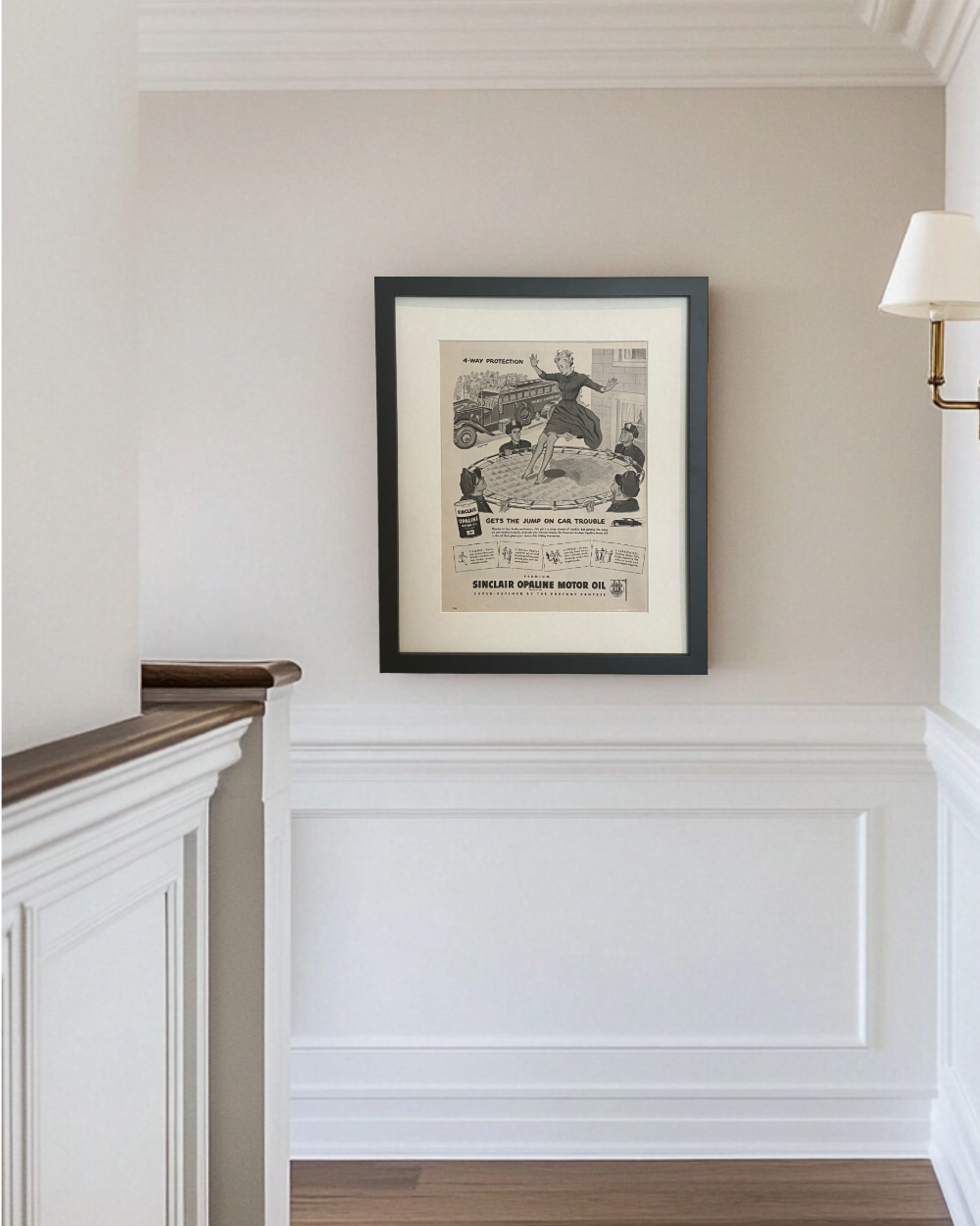 Framed 1949 Sinclair Opaline Motor Oil vintage advertisement displayed in a bright traditional hallway with black frame
