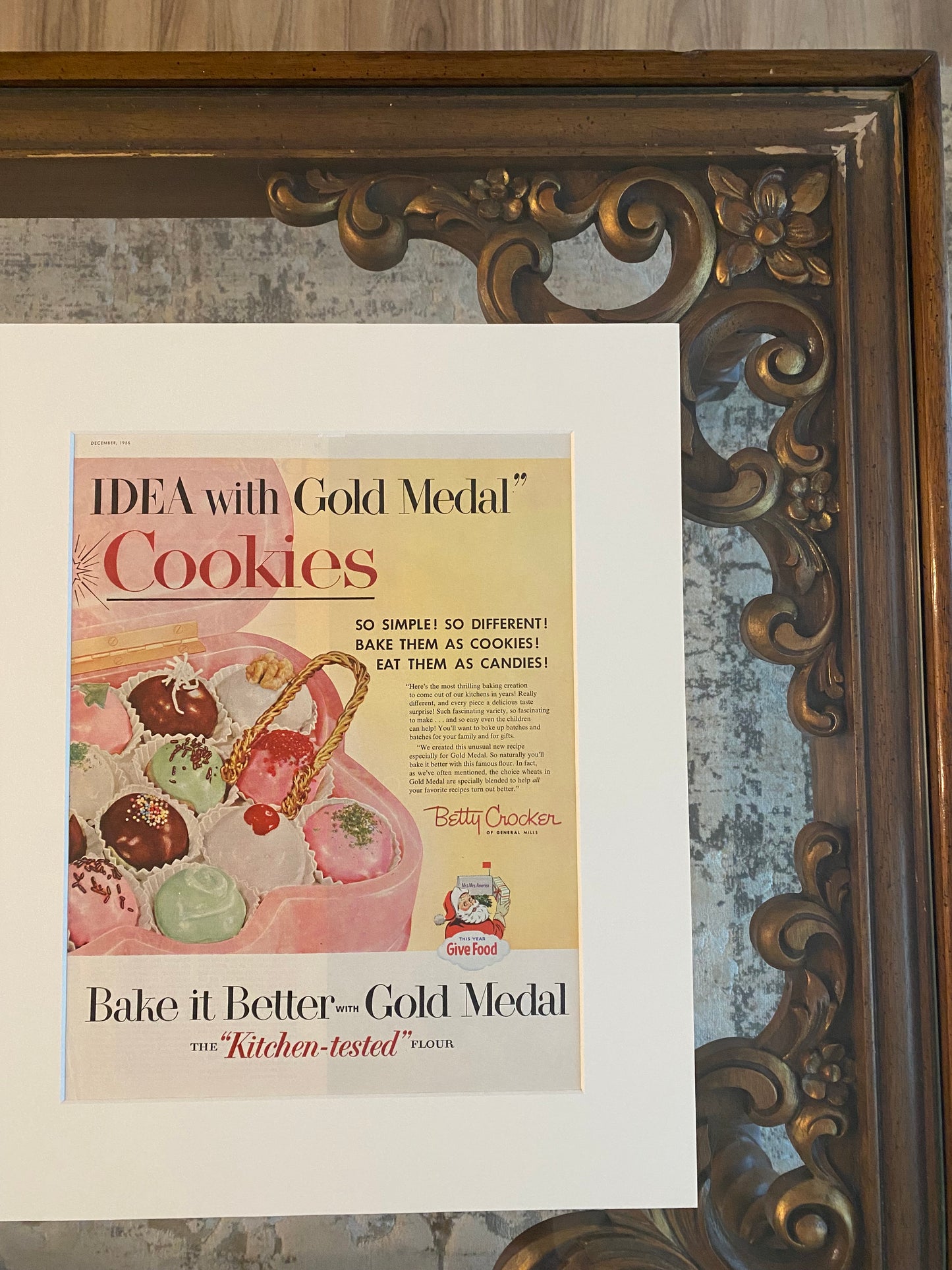 Close-up detail of brown wood frame and archival matting on original Betty Crocker Cookies advertisement