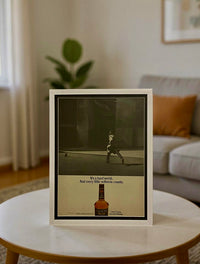 Framed vintage Calvert Extra whiskey advertisement featuring a mid-century street scene and minimalist typography