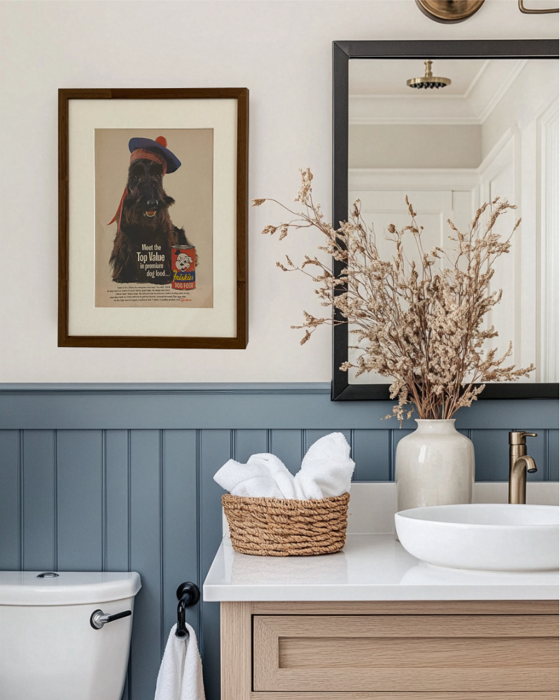Original Friskies Scotty Dog vintage advertisement displayed in a handcrafted brown wood frame in a modern bathroom.
