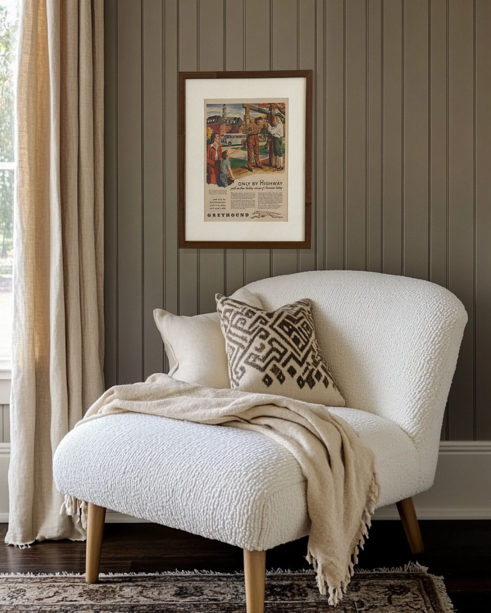 Original Greyhound “Only By Highway” vintage advertisement displayed in a handcrafted brown wood frame above a cozy reading nook.