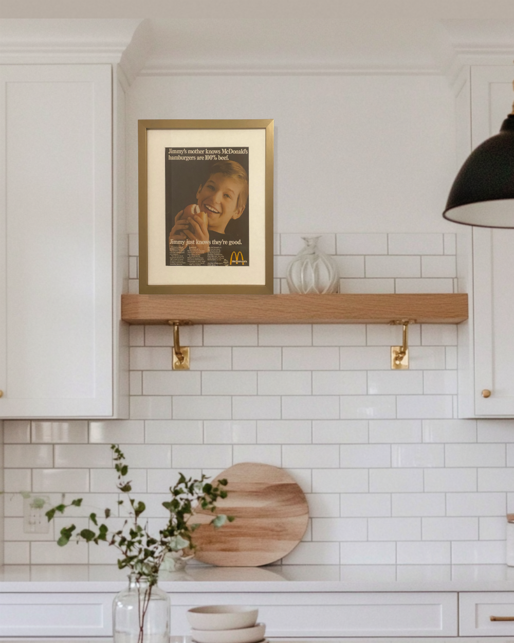 Original McDonald’s “Jimmy’s Mother Knows Hamburgers Are 100% Beef” vintage advertisement displayed on a floating kitchen shelf in a thin brass frame.