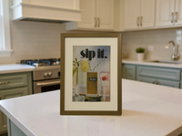 Original Winston Menthol “Sip It.” vintage cigarette advertisement in a thin brass frame styled on a modern kitchen countertop.