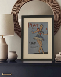 Original 1942 Saturday Evening Post ballerina cover framed in black and styled on a console table in a modern traditional home.