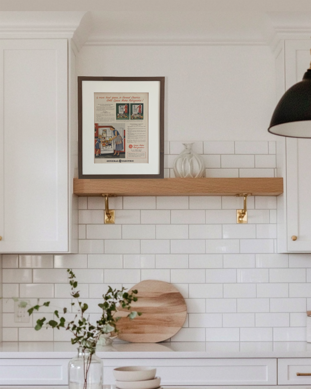 Original 1948 General Electric Space Maker Refrigerator vintage advertisement in a handcrafted walnut frame displayed on a floating kitchen shelf.