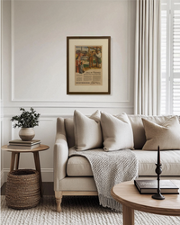 Original Greyhound travel advertisement from the 1940s framed in walnut brown and styled above a cozy reading chair.