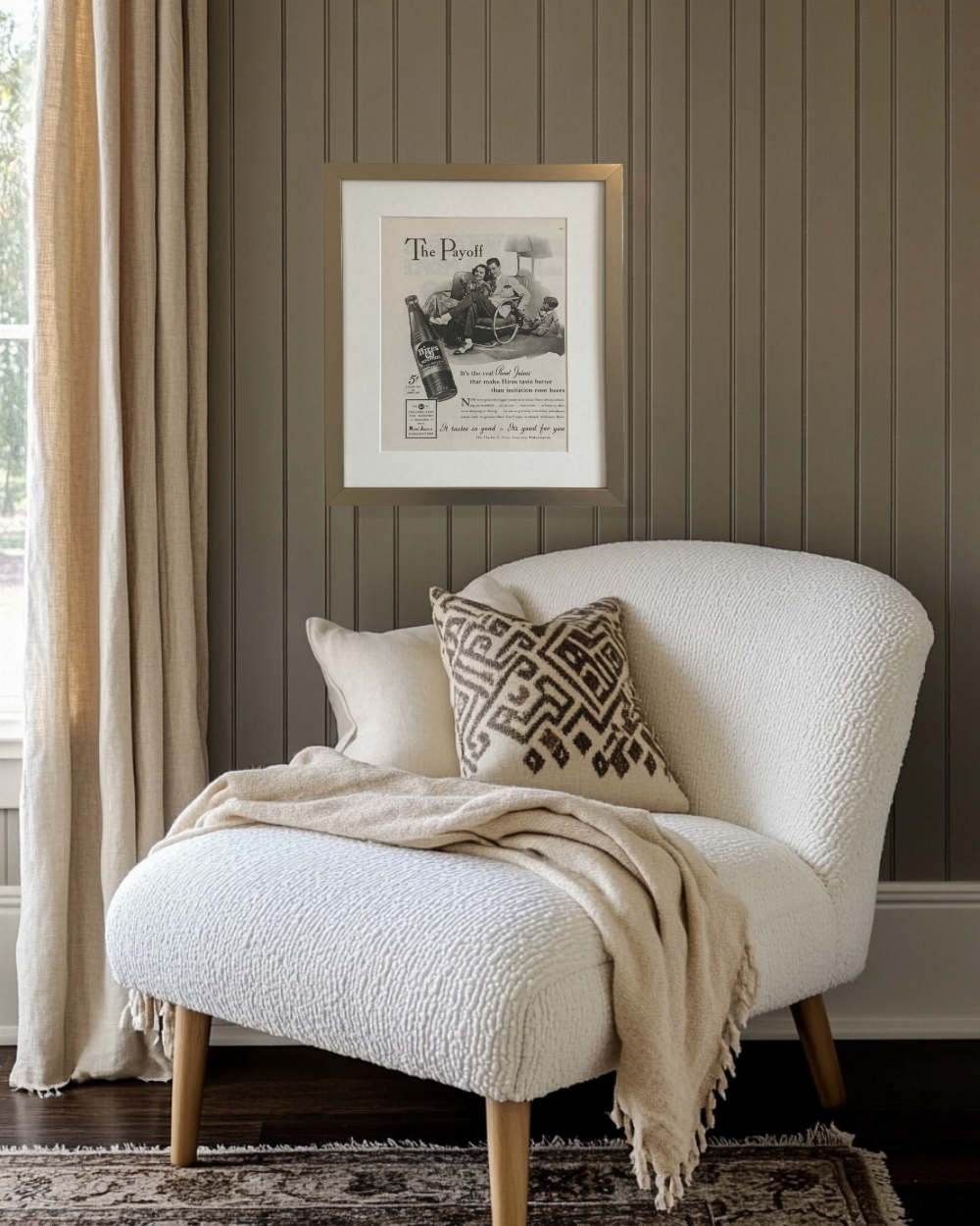 Original Hires Root Beer “The Payoff” vintage advertisement in a brushed brass frame displayed above a neutral reading nook.