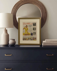 Original 1948 Ivory Flakes magazine advertisement displayed in a brass frame on a dresser beneath a round mirror in a warm neutral bedroom.
