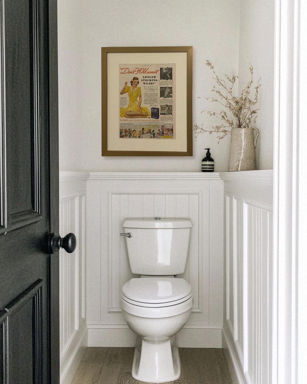 Original 1948 Ivory Flakes magazine advertisement displayed in a brass frame above a powder room toilet with white millwork and neutral decor.
