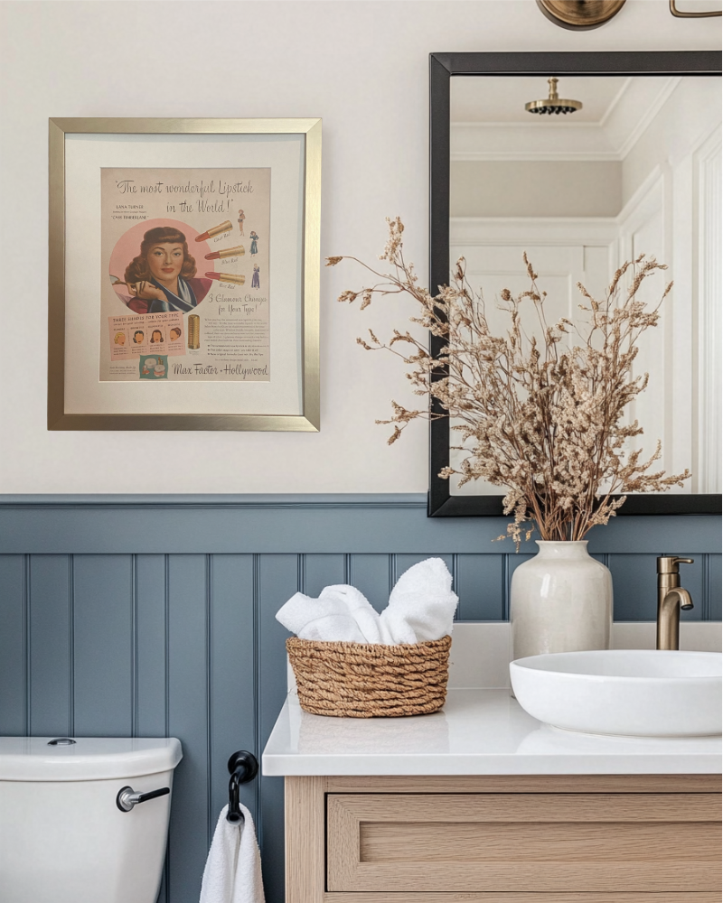 Original Max Factor Hollywood lipstick advertisement in a brushed brass frame styled above a blue bathroom vanity.