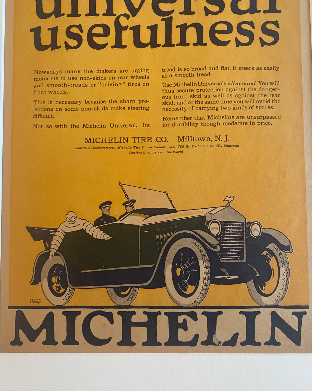 Detailed close-up of the original Michelin advertisement highlighting the vintage typography, automobile illustration, and authentic aged paper.