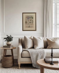 Framed New York World’s Fair vintage advertisement displayed on a living room wall above a neutral sofa in a warm traditional interior.