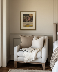 Original 1955 Cadillac vintage advertisement framed in brass and displayed above a cozy bedroom reading nook.