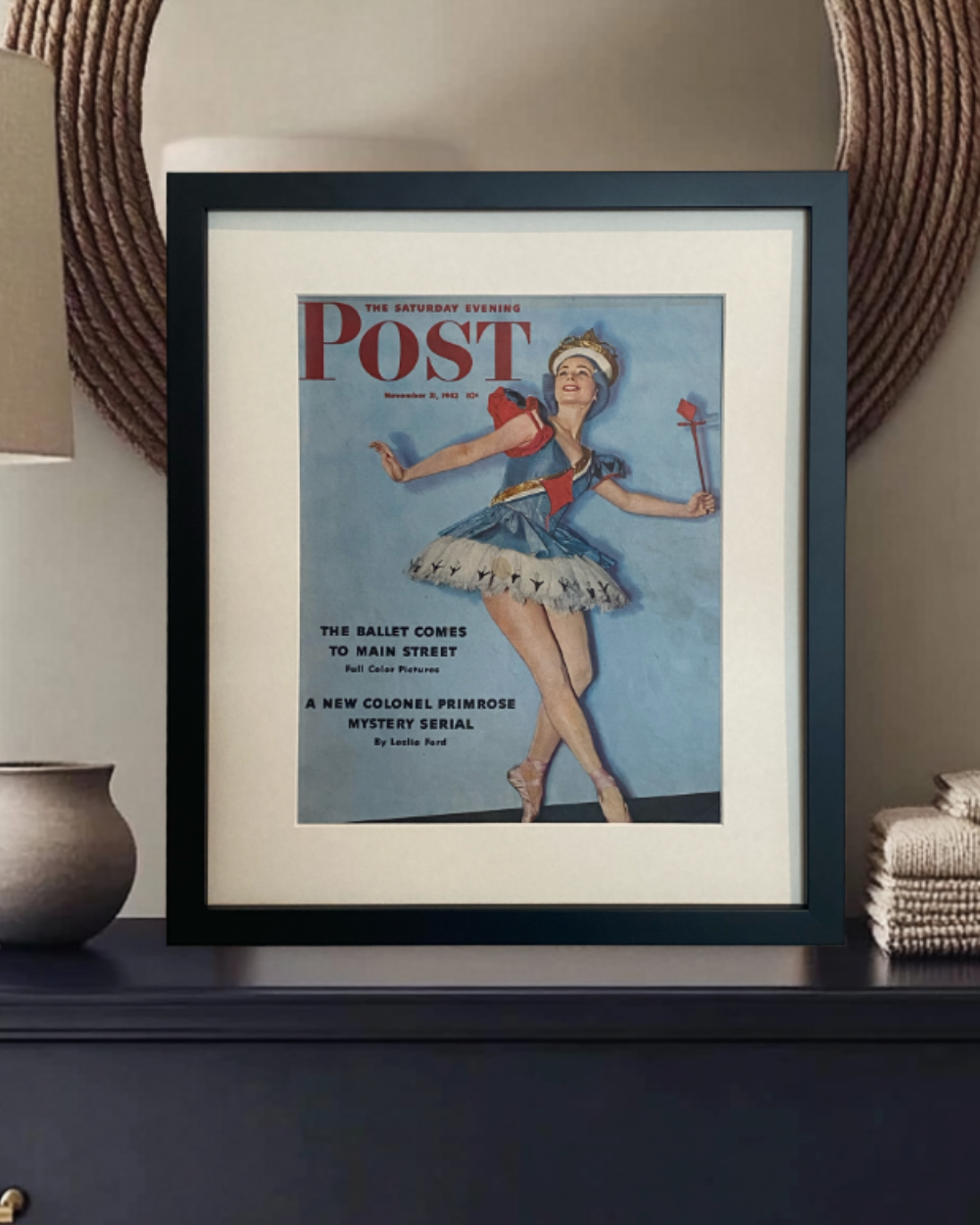 Close view of an original vintage Saturday Evening Post ballerina cover in a black frame with off-white mat