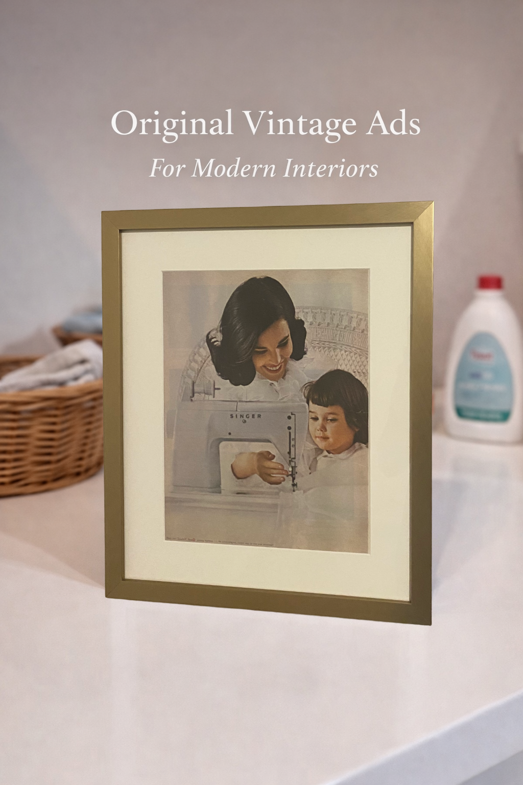 Original vintage Singer advertisement displayed in a warm brass frame beneath the heading “Original Vintage Ads for Modern Interiors.”