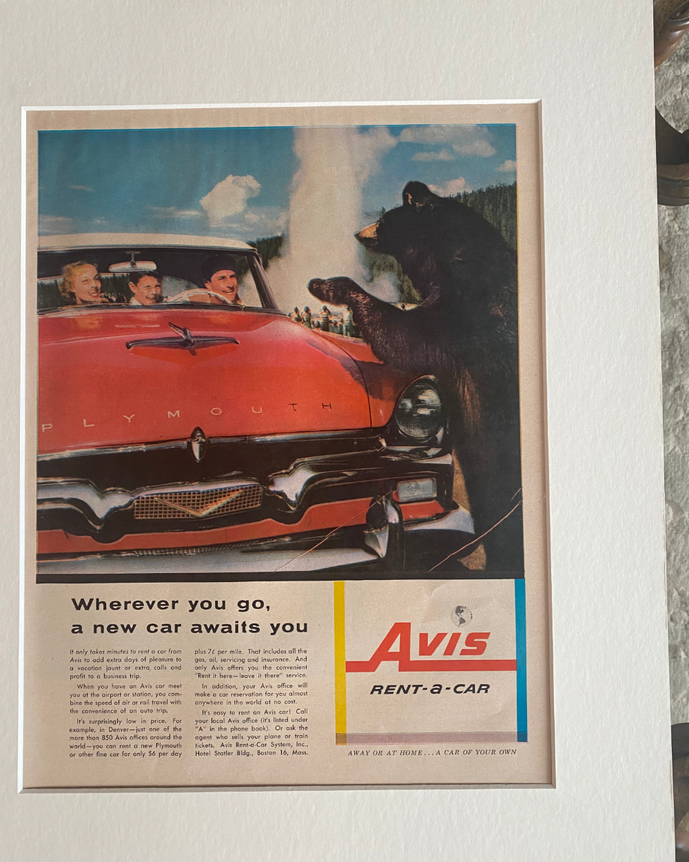 Close-up of an original vintage Avis Rent-a-Car advertisement featuring a red Plymouth, bears and colorful mid-century artwork