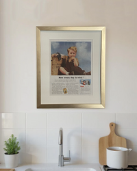 Original vintage Cream of Wheat advertisement beautifully framed in brushed brass and displayed above the counter in a modern kitchen.