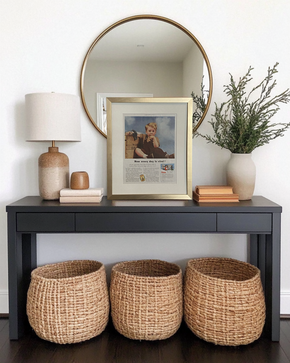 Original vintage Cream of Wheat advertisement in a brushed brass frame styled on a black entryway console with neutral decor.