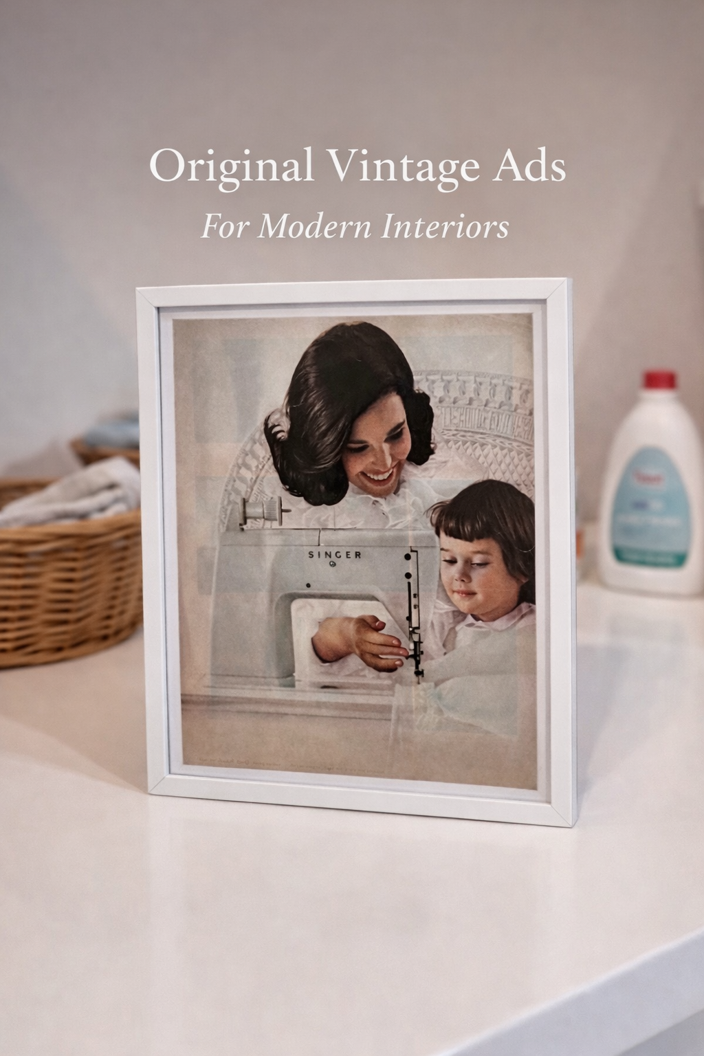 Framed original vintage Singer sewing machine advertisement styled in a modern interior with neutral tones