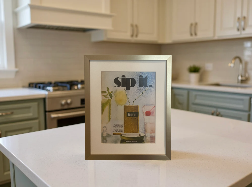Original vintage Winston Menthol advertisement beautifully framed in brushed brass and styled on a modern kitchen counter.