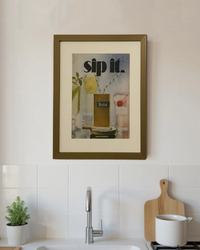 Original Winston Menthol “Sip It.” vintage cigarette advertisement framed in a thin brass frame displayed on a modern kitchen wall.