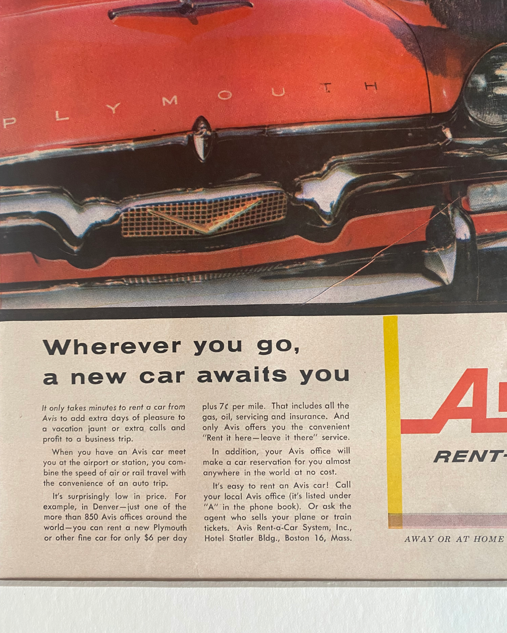 Detail of an authentic vintage Avis advertisement showing the red Plymouth, period typography and original aged magazine paper