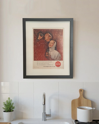 Framed original vintage Coca-Cola advertisement styled in a bright modern kitchen