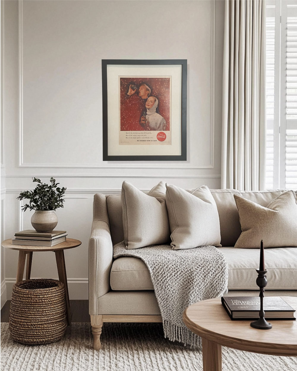 Original framed vintage Coca-Cola advertisement adding rich red color to a neutral modern living room