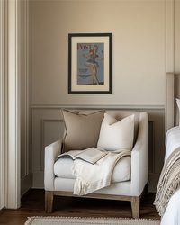 Original framed Saturday Evening Post ballerina cover displayed above a reading chair in a cozy bedroom nook.